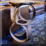 F11. Side table with pedestal made from metal rings. 